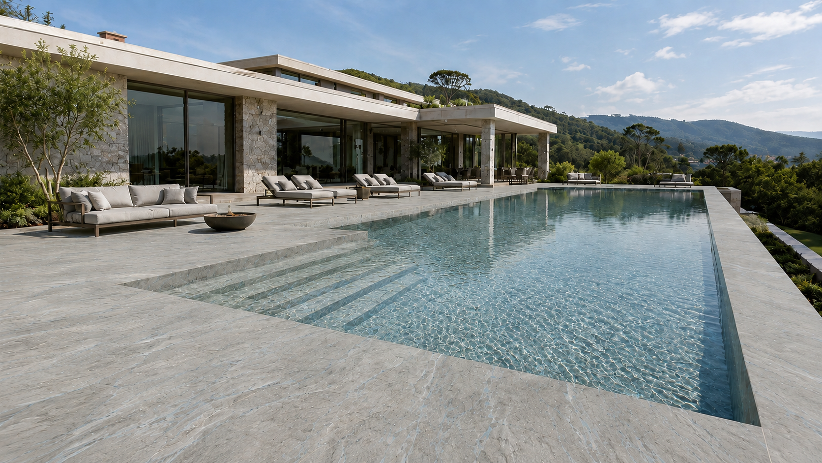 Piscine à débordement d'une villa contemporaine — vue de jour, montagnes en arrière-plan